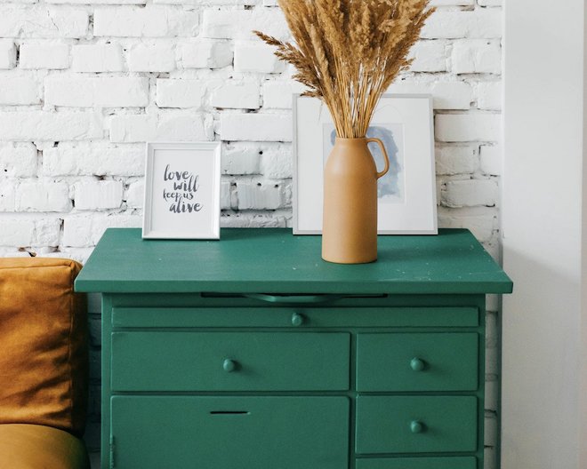 Drawers with picture frames and a vase